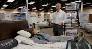 Sean, owner of Mattress World Northwest demonstrating and adjustable base with a customer.