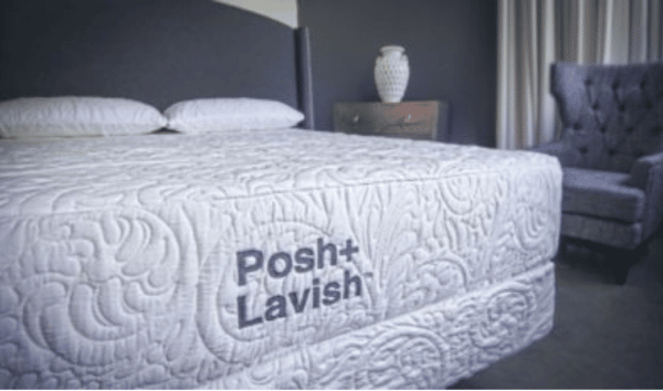 white embridered luxury mattress with the name posh+lavish sewn onto it