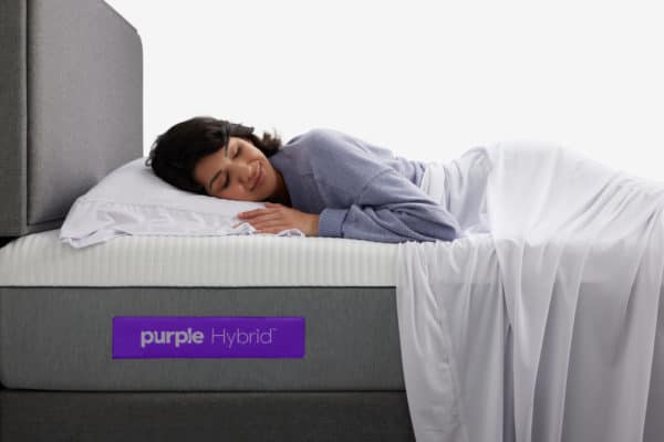 Woman sleeping on Purple Hybrid Mattress with base