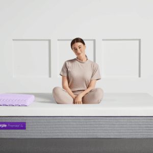 Woman sitting on Purple Hybrid Premier 4 mattress