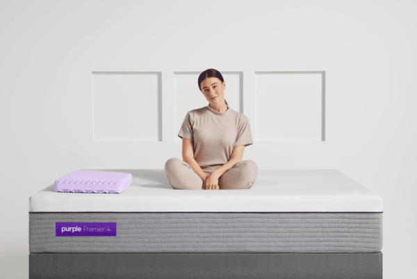 Woman sitting on Purple Hybrid Premier 4 mattress