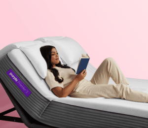 Woman reading a book on a Purple Hybrid Premier 3 bed