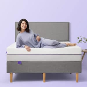 Woman laying on Purple complete comfort Mattress with base