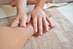 image of a person giving a hand and arm massage