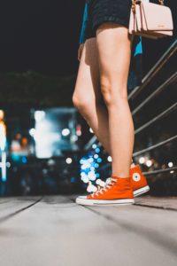 picture of a person's legs who is standing outside at night
