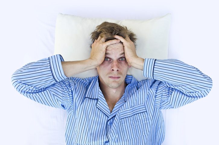 A man not able to get to sleep because of stress, insomnia