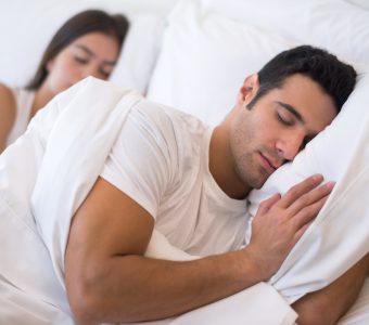 man lying on bed looking comfortable