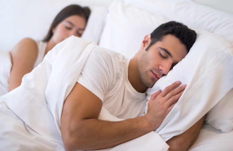 man lying on bed looking comfortable