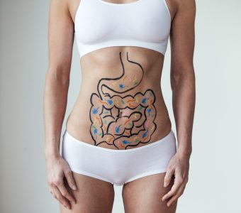 woman wearing white sports bra and underwear with diagram of metabolism process drawn on her stomach