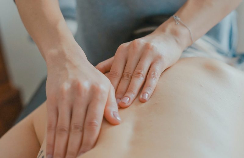 Image of hands on a person's back giving a massage