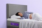 Woman laying on a purple complete comfort mattress