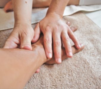 image of a person giving a hand and arm massage